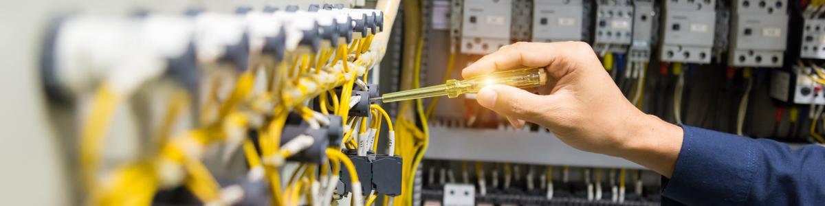 electricians-hands-testing-current-electric-control-panel